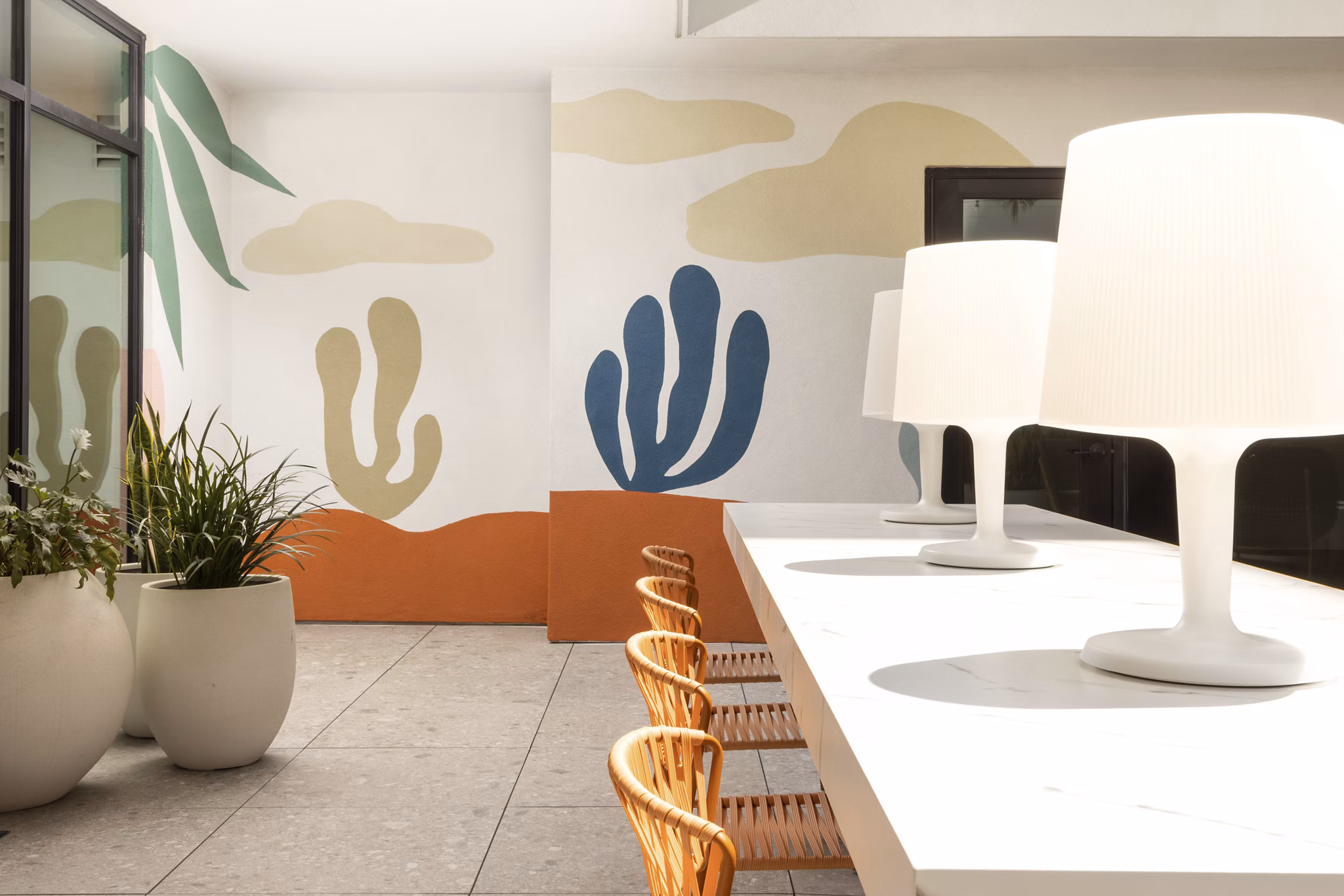 Clubhouse with modern design and open seating area at The Charlie Mar Vista Apartments