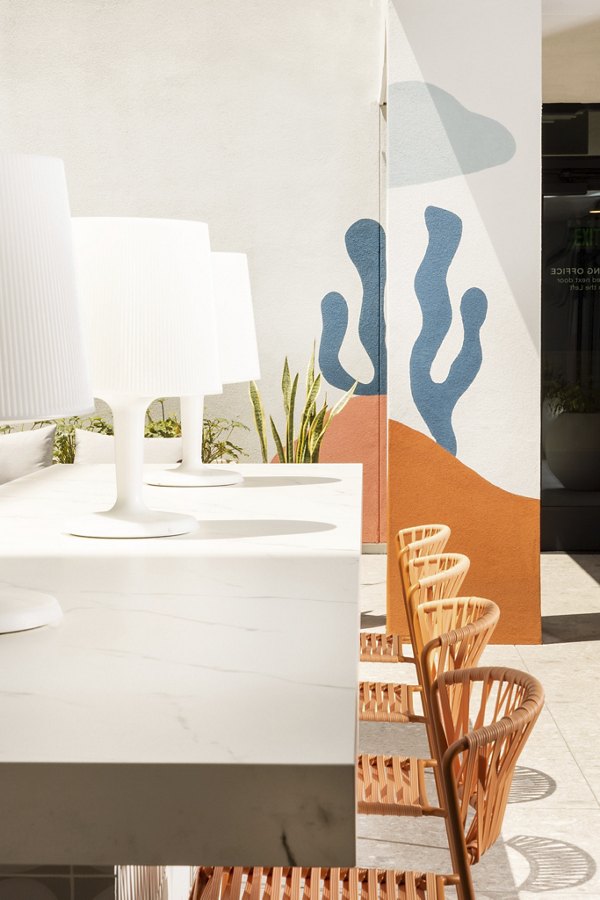 Clubhouse with modern design and cozy seating at The Charlie Mar Vista Apartments