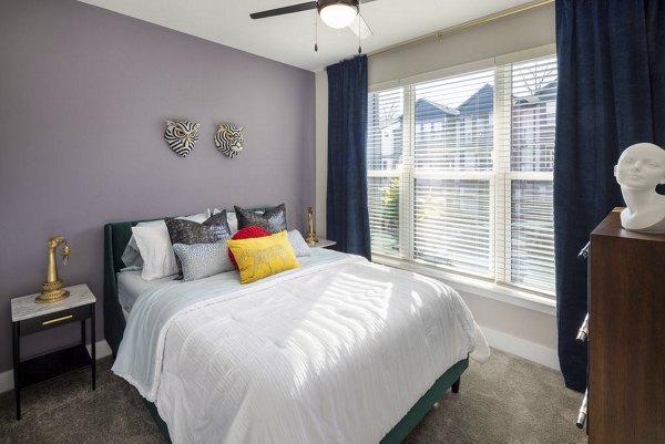 Cozy bedroom with modern decor at Broadstone Pullman Apartments, featuring stylish furnishings and ample natural light