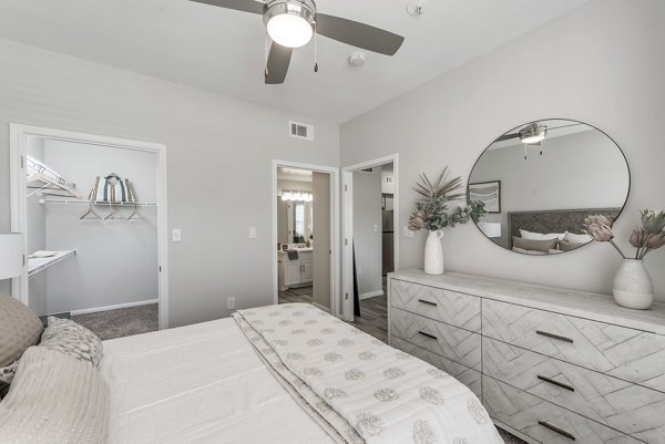 Cozy bedroom with elegant decor in Mirabella Apartments