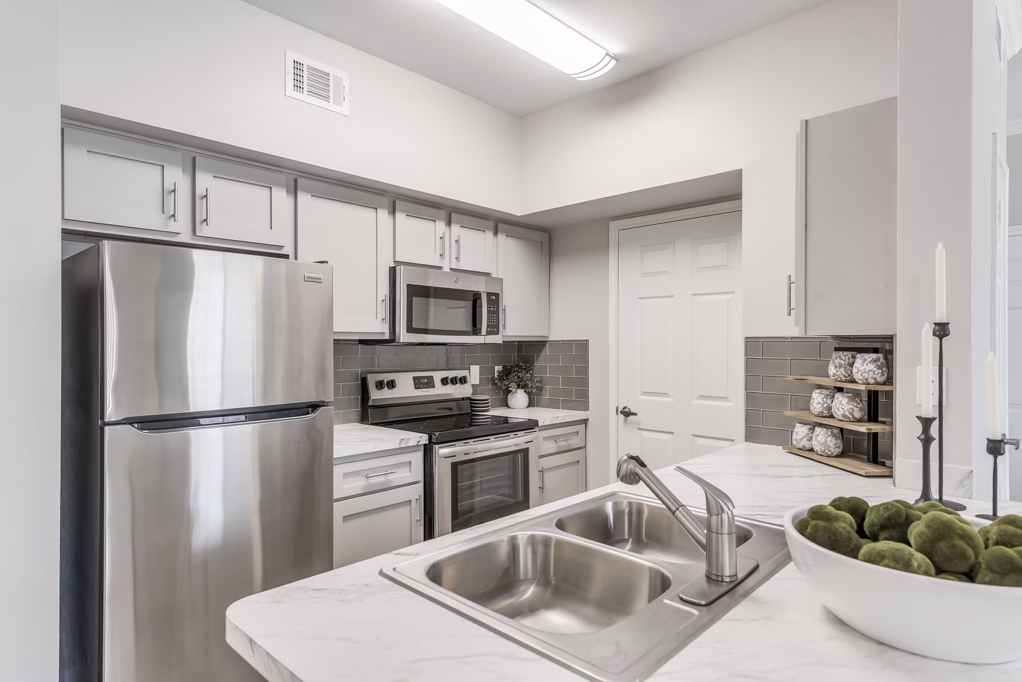 Modern kitchen with stainless steel appliances in Mirabella Apartments, offering a luxurious living experience