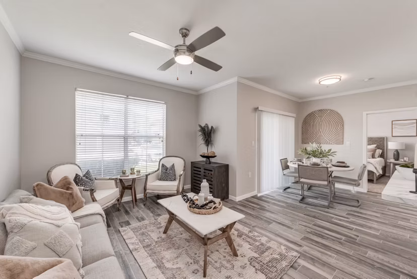 Spacious living room with modern furnishings in Mirabella Apartments, featuring a cozy ambiance and elegant decor