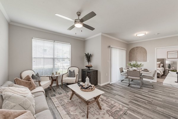 Spacious living room with modern furnishings in Mirabella Apartments, featuring a cozy ambiance and elegant decor