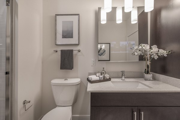 Luxurious bathroom with marble countertops and modern fixtures at The Eliot on Ocean Apartments