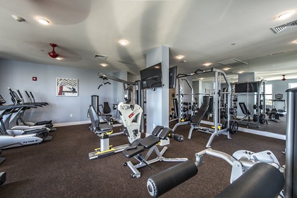 Modern gym with state-of-the-art exercise equipment at luxury apartments