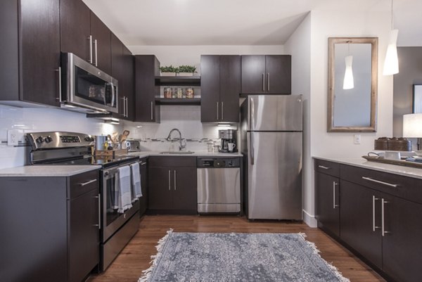 Modern kitchen with stainless steel appliances at The Eliot on Ocean Apartments