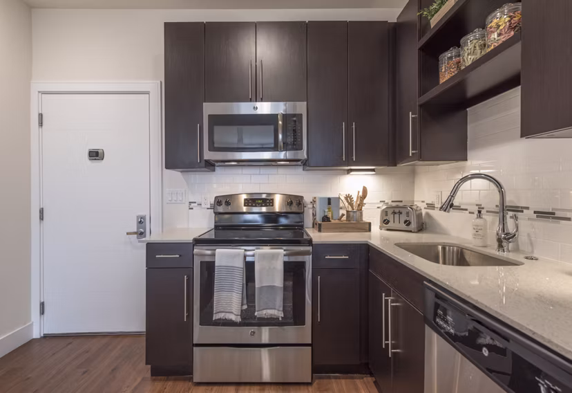 Modern kitchen featuring sleek countertops and stainless steel appliances at The Eliot on Ocean Apartments