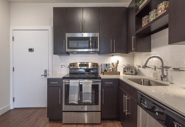 Modern kitchen featuring sleek countertops and stainless steel appliances at The Eliot on Ocean Apartments