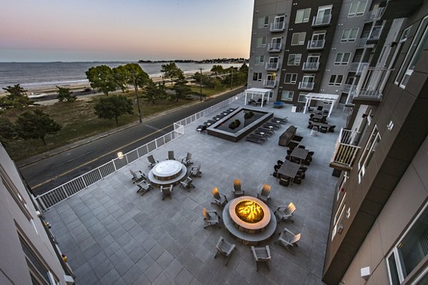 Outdoor patio seating with fire pits and ocean views at luxury apartments