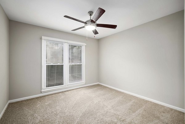 Spacious bedroom with modern decor at Regent Place Apartments with large windows