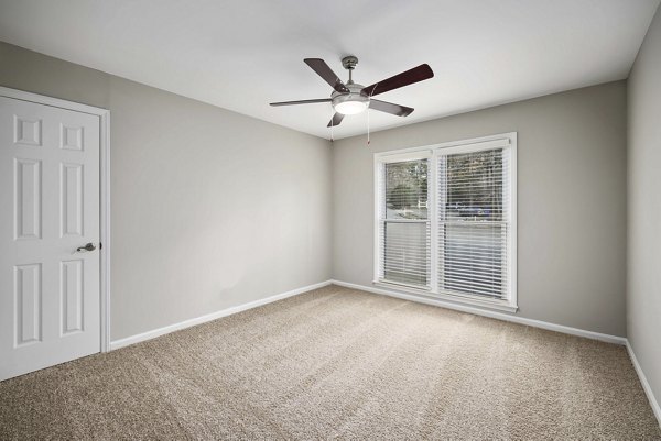 Elegant bedroom with large windows and modern decor at Regent Place Apartments, a Greystar luxury property