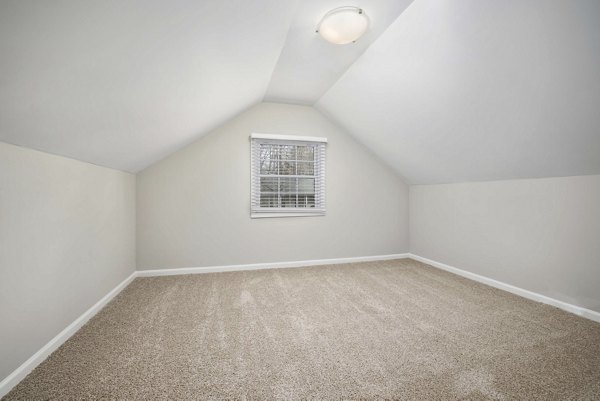 Luxurious bedroom featuring elegant decor and ample natural light at Regent Place Apartments in the heart of the city