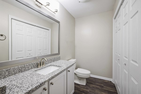 Bathroom featuring elegant marble countertops and sleek fixtures in Regent Place Apartments