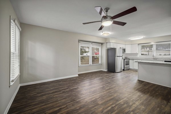Modern living room with contemporary furnishings at Regent Place Apartments, featuring a neutral color palette and large windows