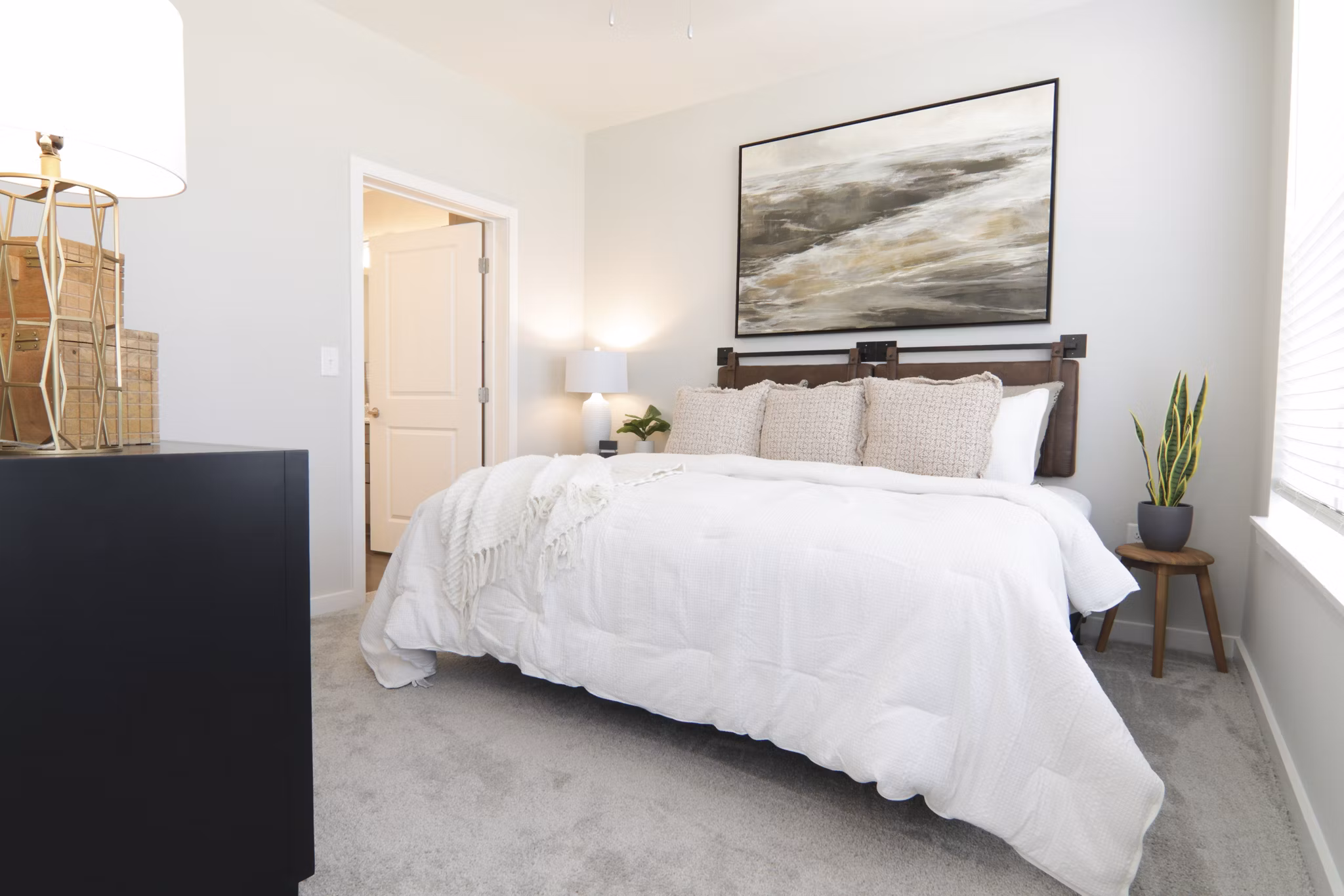 Elegant bedroom with designer furnishings at The Ravelle at Ridgeview Apartments
