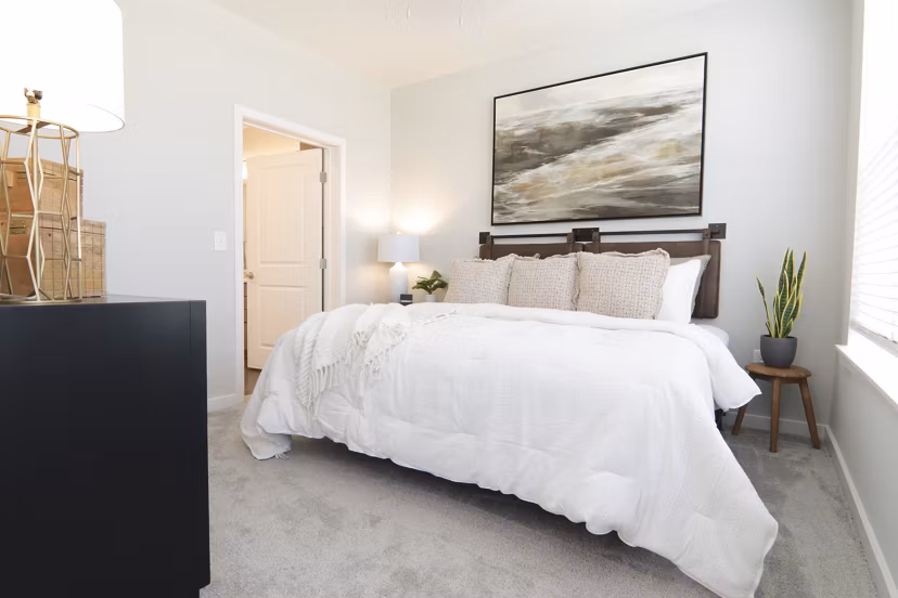 Elegant bedroom with designer furnishings at The Ravelle at Ridgeview Apartments
