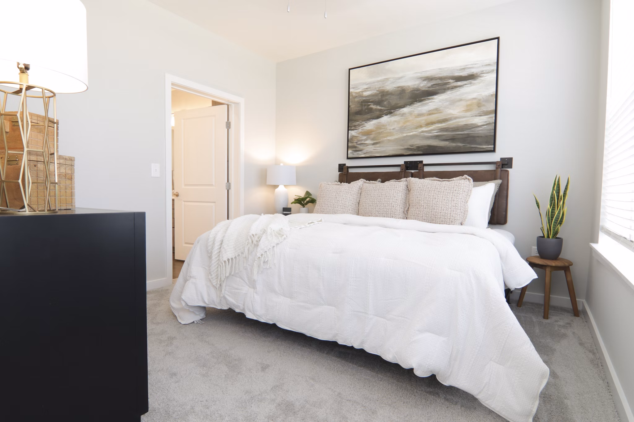 Elegant bedroom with designer furnishings at The Ravelle at Ridgeview Apartments