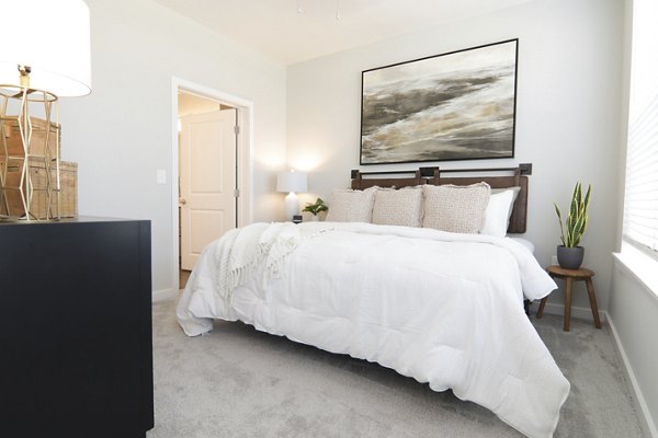 Elegant bedroom with designer furnishings at The Ravelle at Ridgeview Apartments