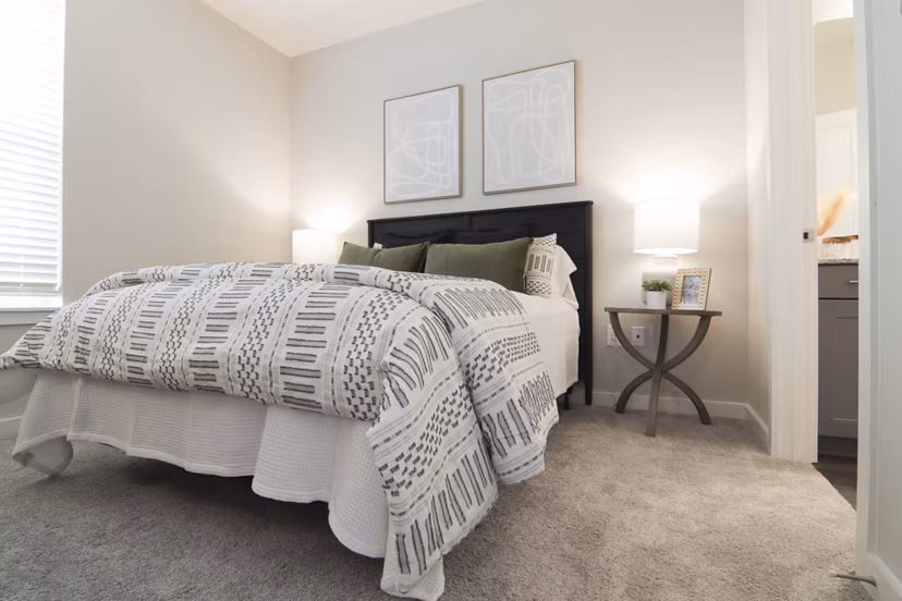 Elegant bedroom with designer furnishings at The Ravelle at Ridgeview Apartments