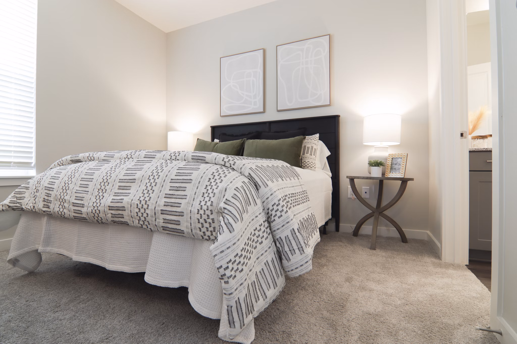 Elegant bedroom with designer furnishings at The Ravelle at Ridgeview Apartments