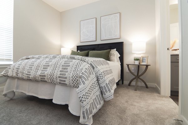 Elegant bedroom with designer furnishings at The Ravelle at Ridgeview Apartments