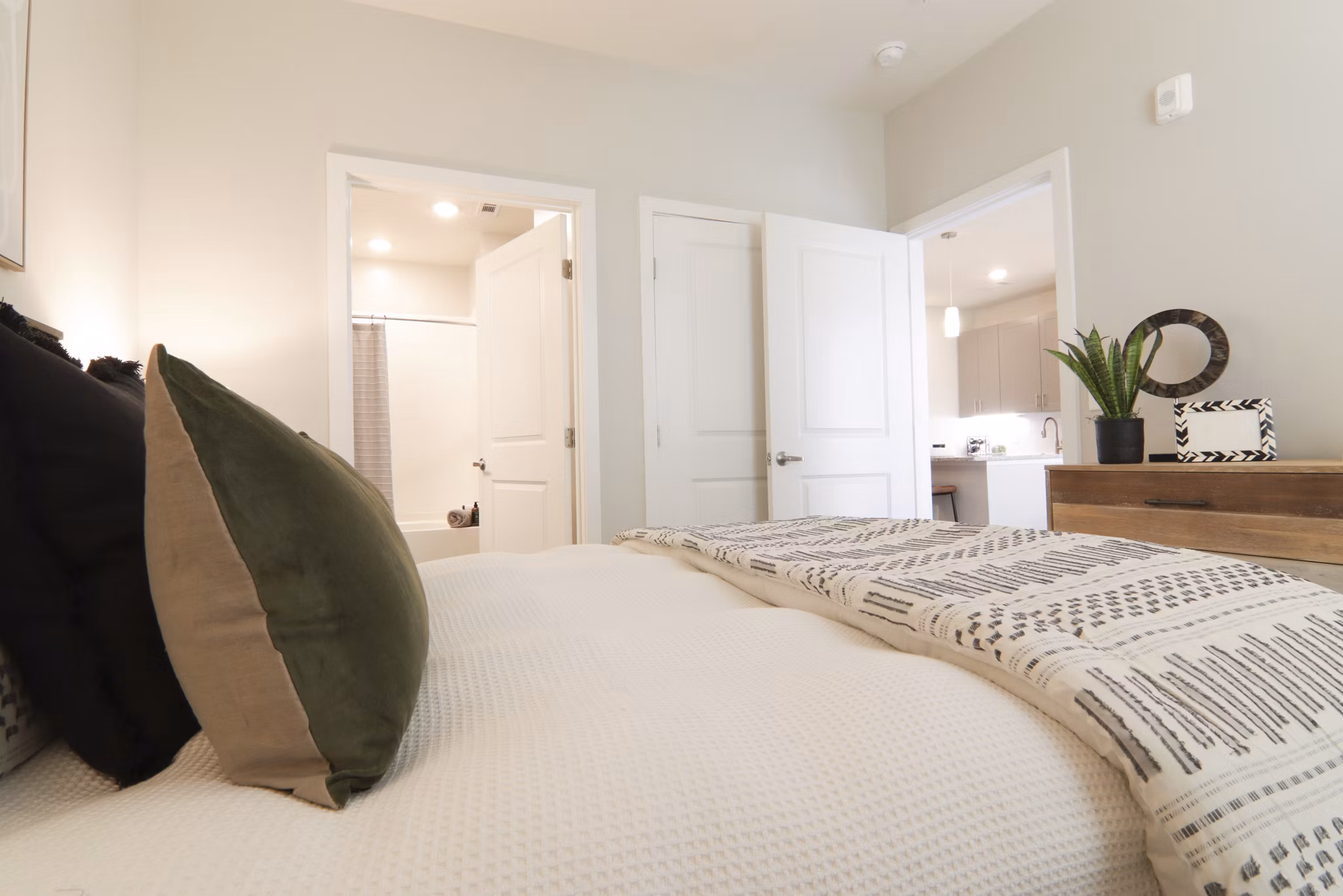 Cozy bedroom with soft lighting at The Ravelle at Ridgeview Apartments