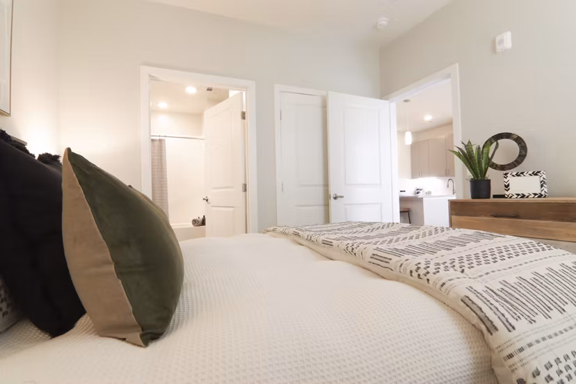 Cozy bedroom with soft lighting at The Ravelle at Ridgeview Apartments