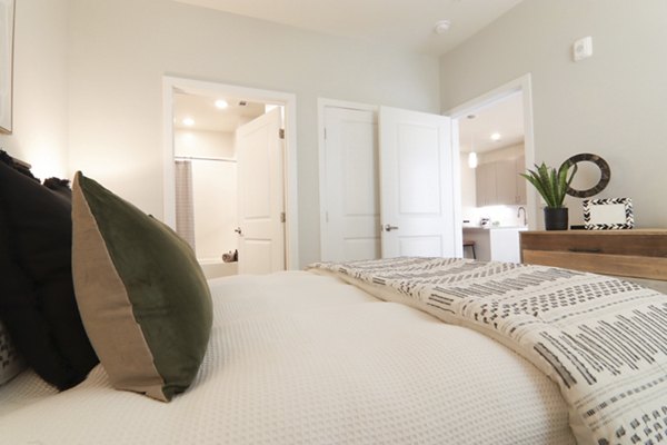 Cozy bedroom with soft lighting at The Ravelle at Ridgeview Apartments