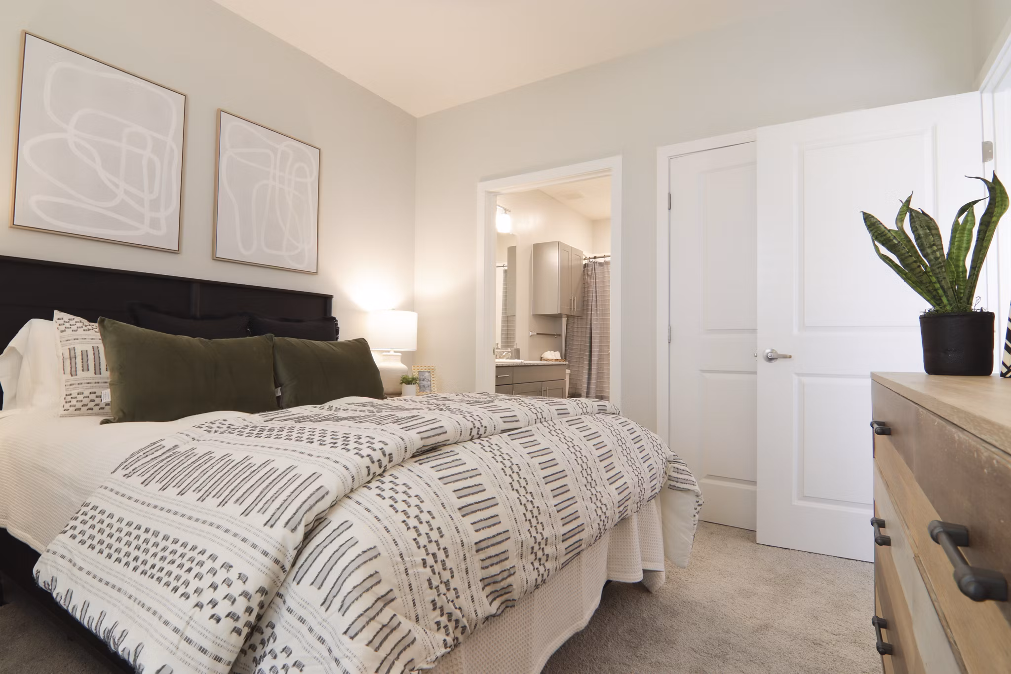 Contemporary bedroom with stylish decor at The Ravelle at Ridgeview Apartments