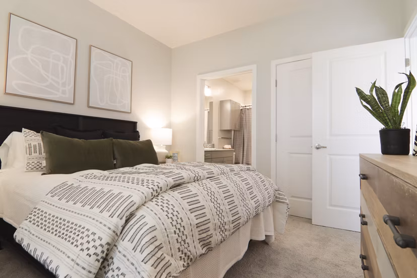 Contemporary bedroom with stylish decor at The Ravelle at Ridgeview Apartments