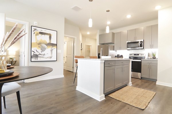 Modern kitchen with stainless steel appliances at The Ravelle at Ridgeview Apartments