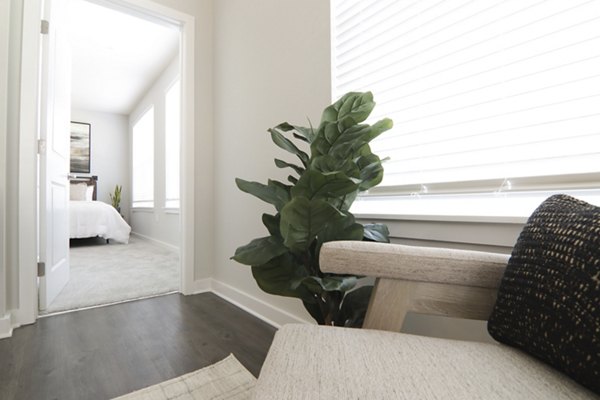 Modern living room with sleek furnishings at The Ravelle at Ridgeview Apartments, offering luxury lifestyle in a serene setting