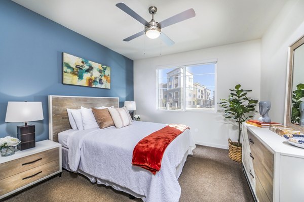 Cozy bedroom with modern design features at Alcove Apartments, luxury living experience in a stylish setting