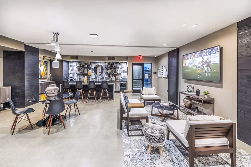 Modern clubhouse with stylish seating and fireplace at Alcove Apartments, a luxury Greystar community