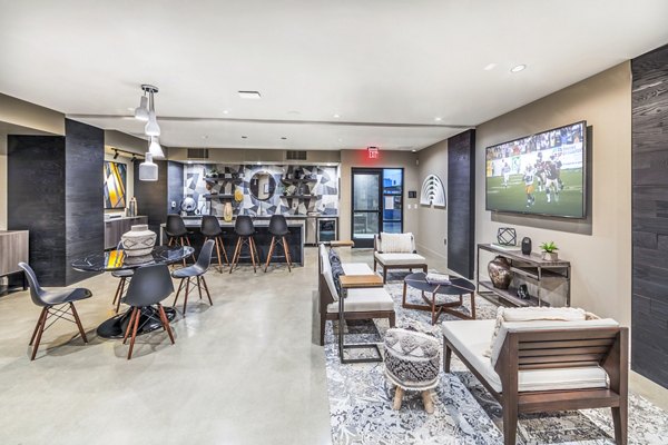 Modern clubhouse with stylish seating and fireplace at Alcove Apartments, a luxury Greystar community