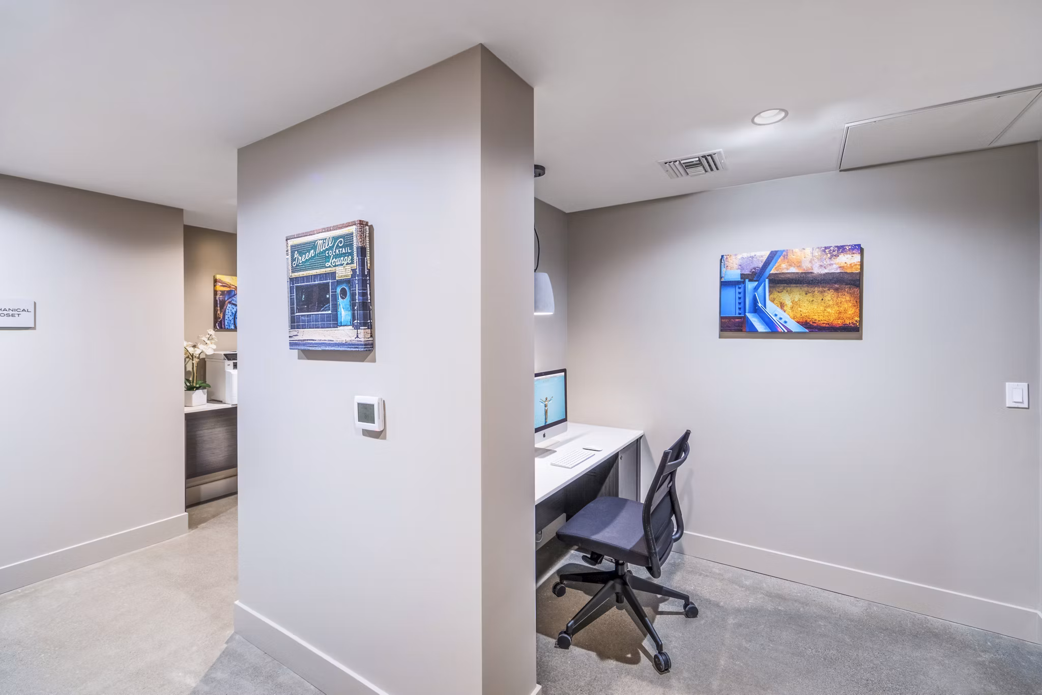 Modern clubhouse business center with sleek workstations at Alcove Apartments