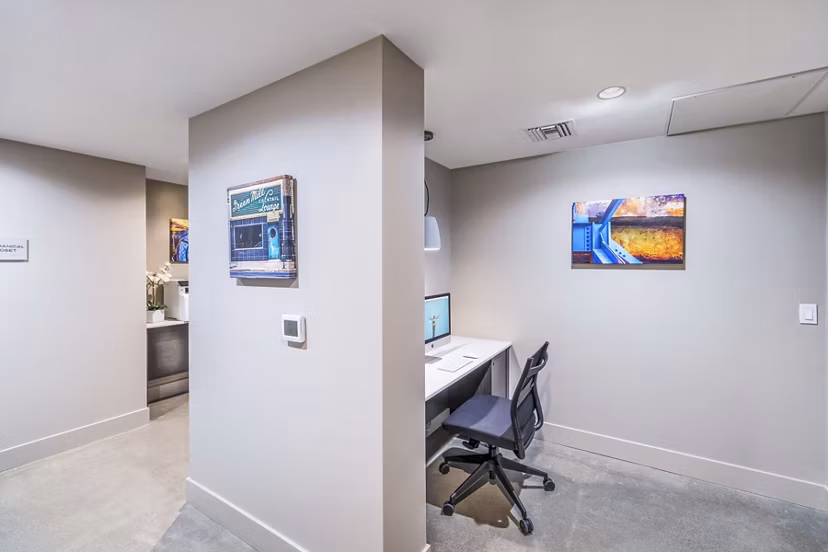 Modern clubhouse business center with sleek workstations at Alcove Apartments