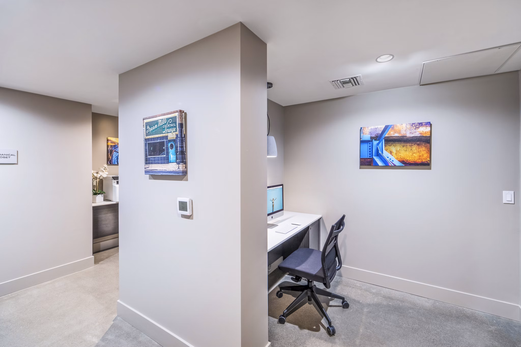 Modern clubhouse business center with sleek workstations at Alcove Apartments