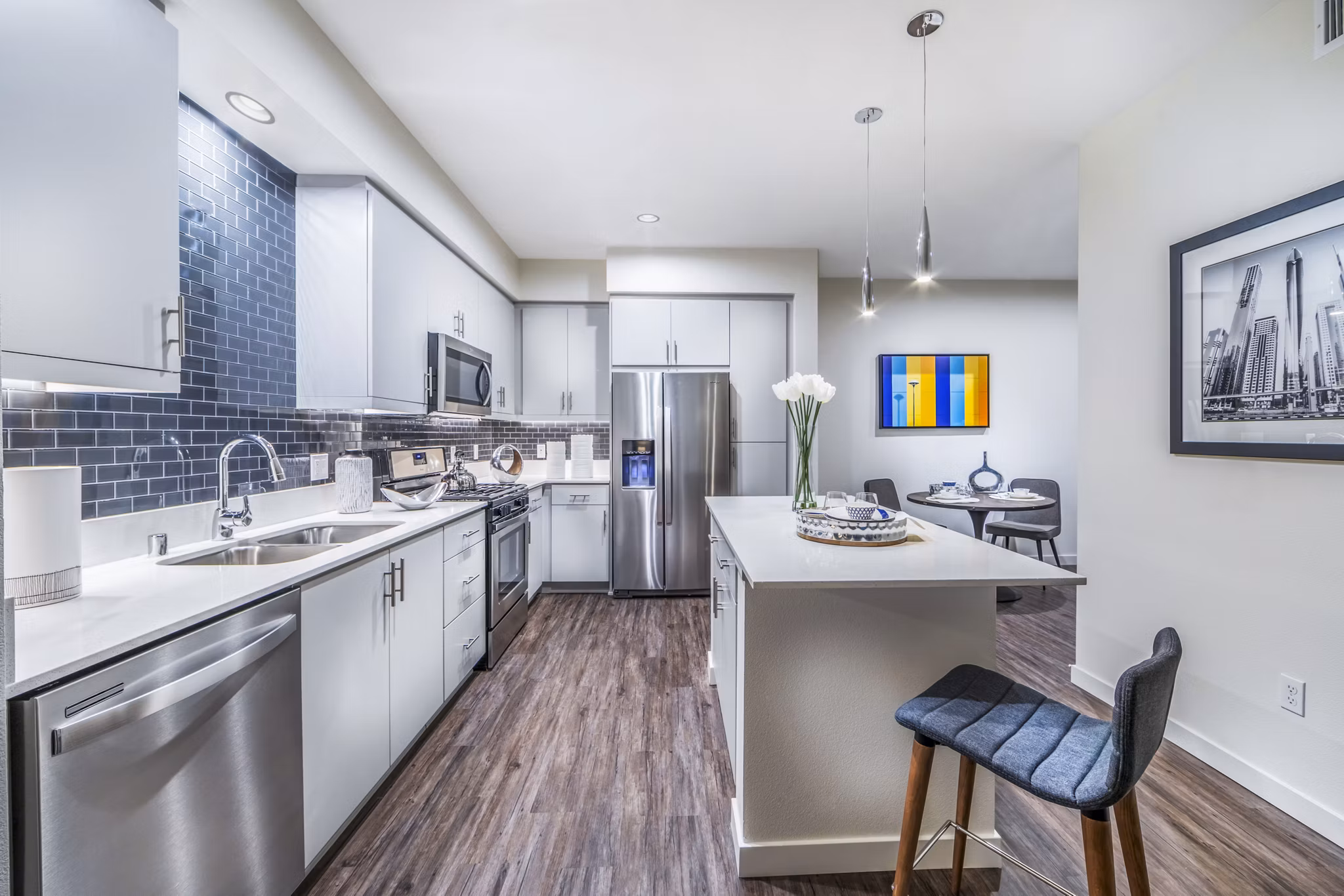 Modern kitchen with stainless steel appliances and quartz countertops at Alcove Apartments, a Greystar luxury apartment community
