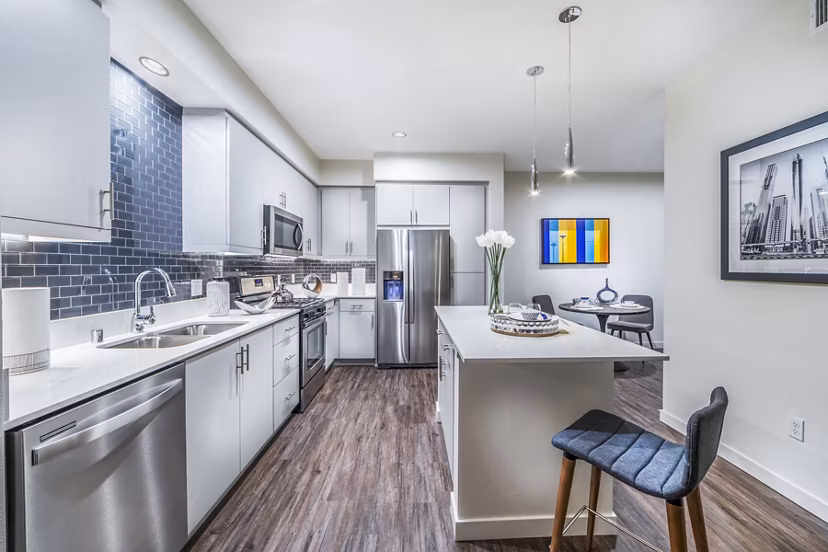 Modern kitchen with stainless steel appliances and quartz countertops at Alcove Apartments, a Greystar luxury apartment community
