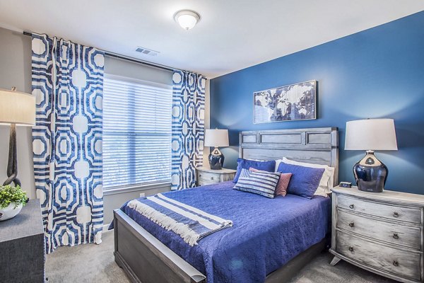 Elegant bedroom with stylish decor and natural lighting at Everleigh Cool Springs Apartments