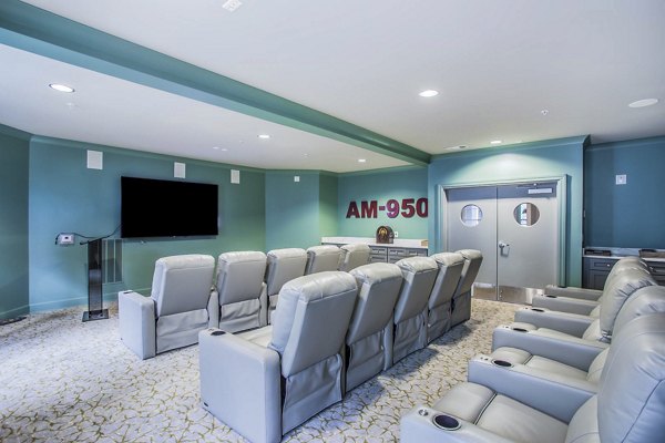 Clubhouse theater with plush seating and large screen at Everleigh Cool Springs Apartments