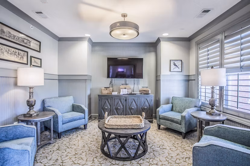 Modern clubhouse with lounge seating and large windows at Everleigh Cool Springs Apartments