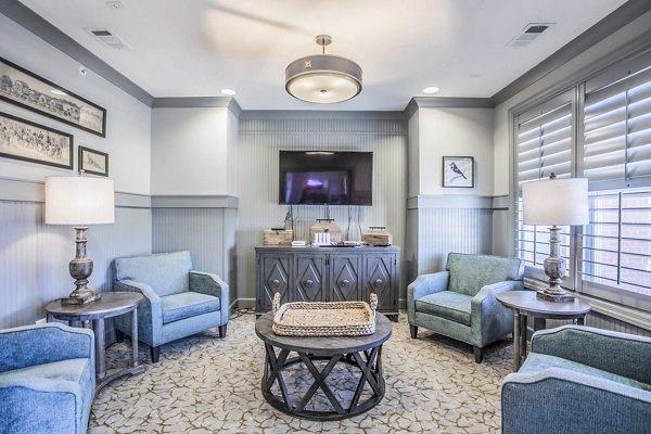 Modern clubhouse with lounge seating and large windows at Everleigh Cool Springs Apartments