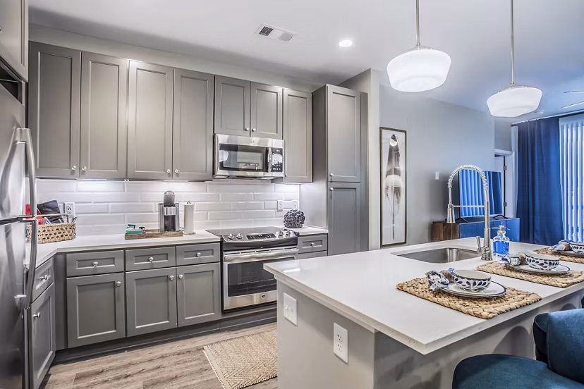 Modern kitchen with stainless steel appliances at Everleigh Cool Springs Apartments