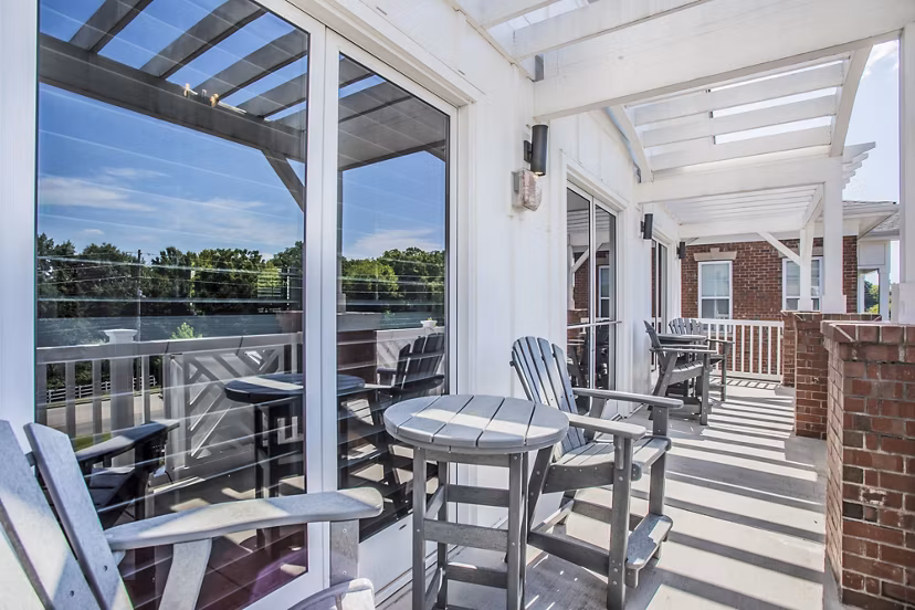 Outdoor seating on clubhouse patio at Everleigh Cool Springs Apartments, offering luxury leisure spaces