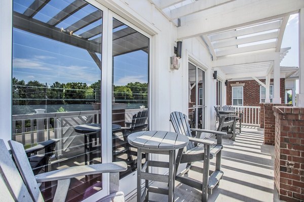 Outdoor seating on clubhouse patio at Everleigh Cool Springs Apartments, offering luxury leisure spaces