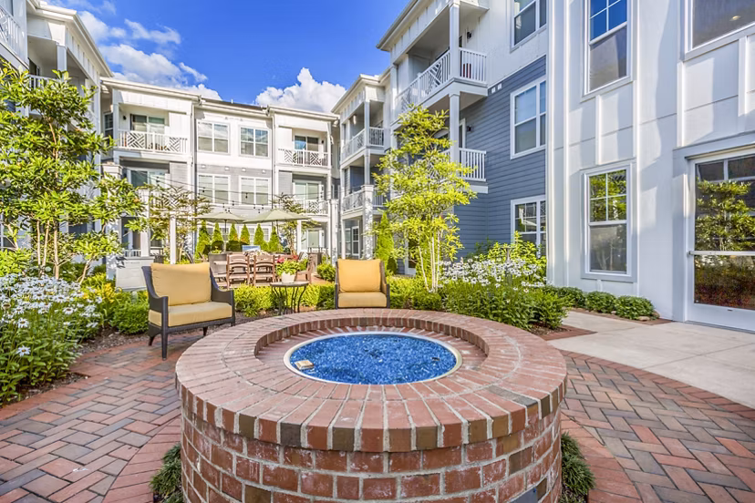 Outdoor fire pit patio at Everleigh Cool Springs Apartments, offering a cozy relaxation spot in this premium property