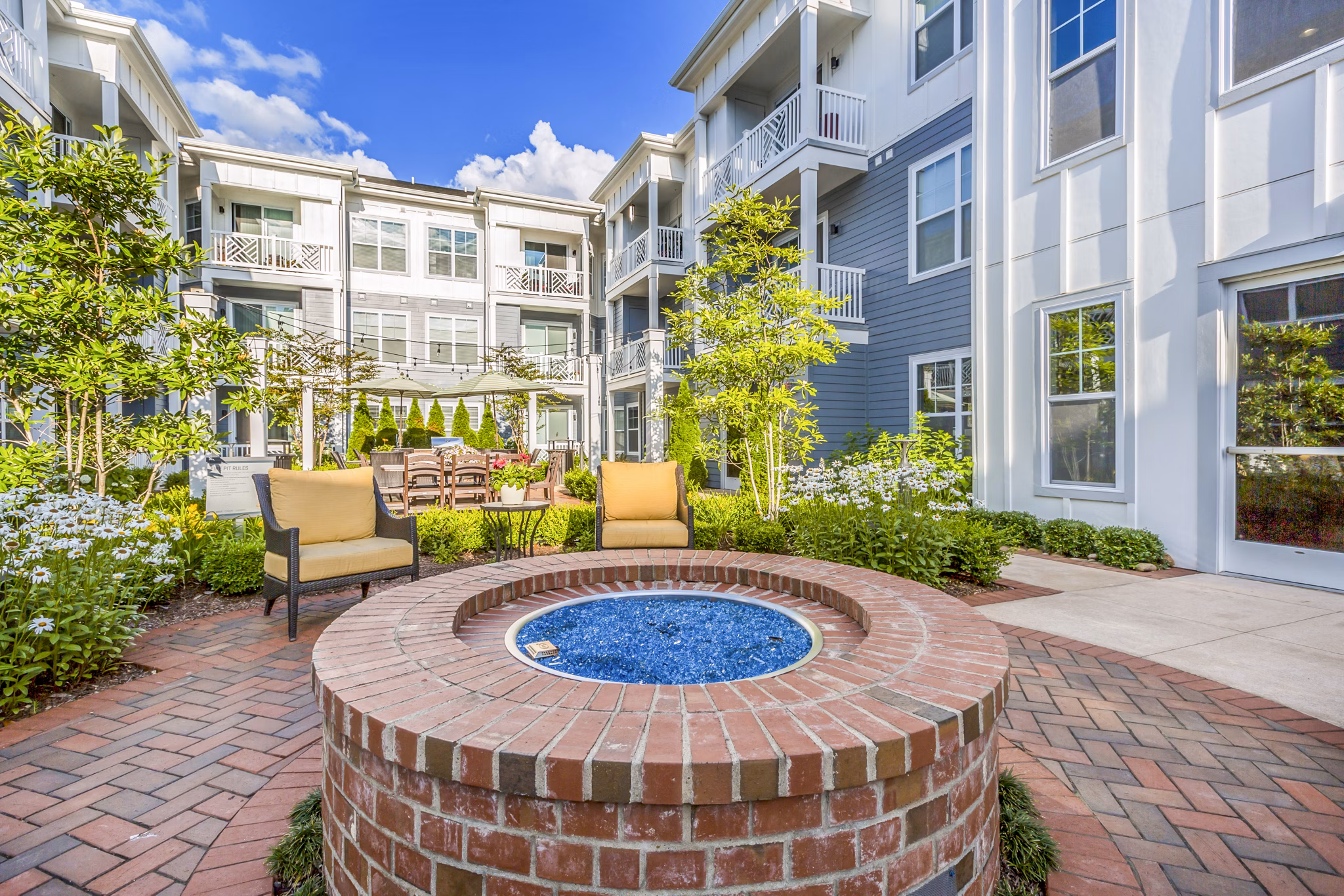 Outdoor fire pit patio at Everleigh Cool Springs Apartments, offering a cozy relaxation spot in this premium property