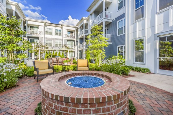 Outdoor fire pit patio at Everleigh Cool Springs Apartments, offering a cozy relaxation spot in this premium property